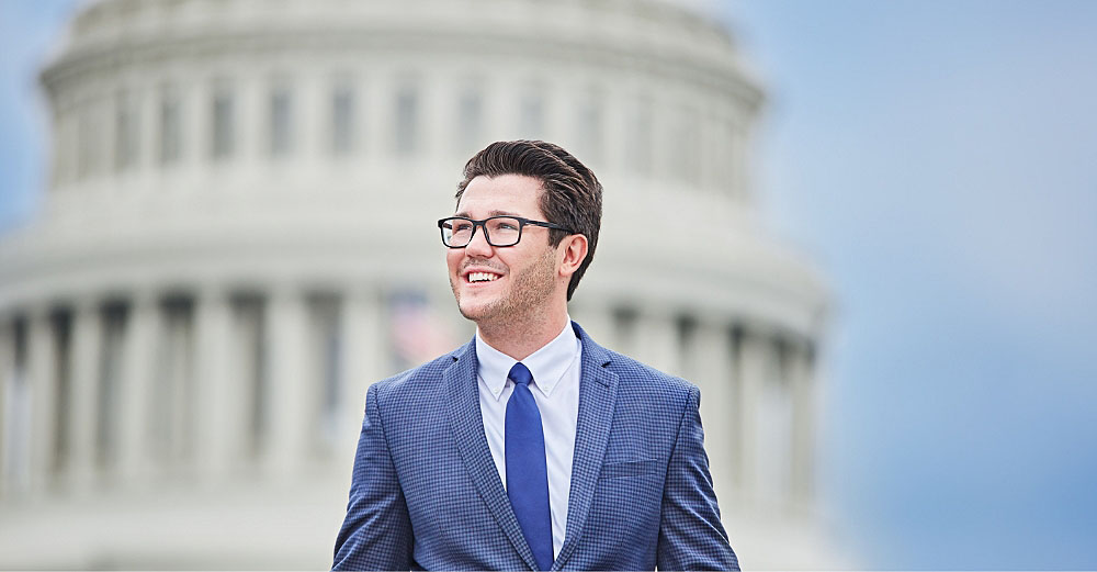 Professional man smiling with capital building in the background