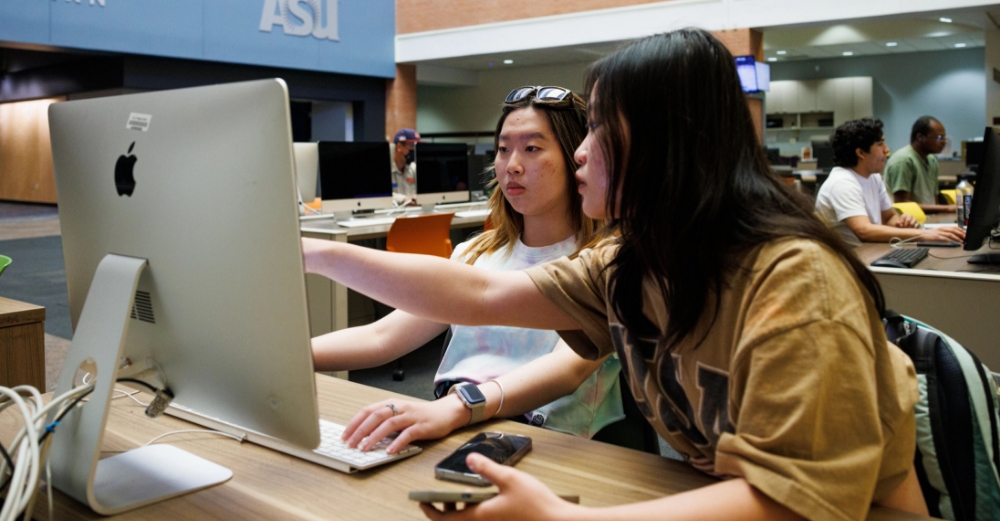Two female students working on a computer