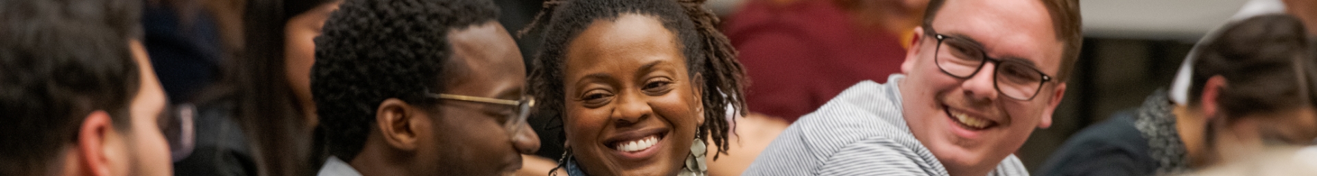 Man and Woman smiling in a crowd of people