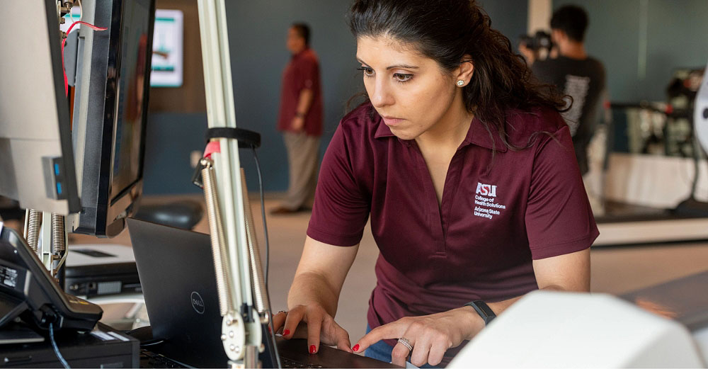ASU worker focused while typing on a computer