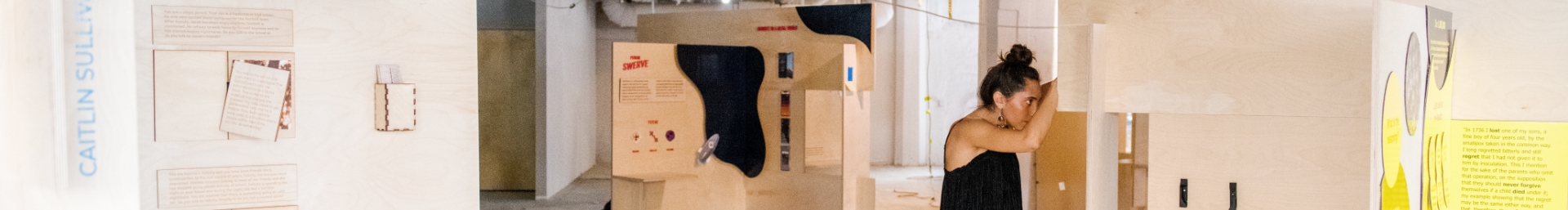 Female student working on wood boards for an exhibition