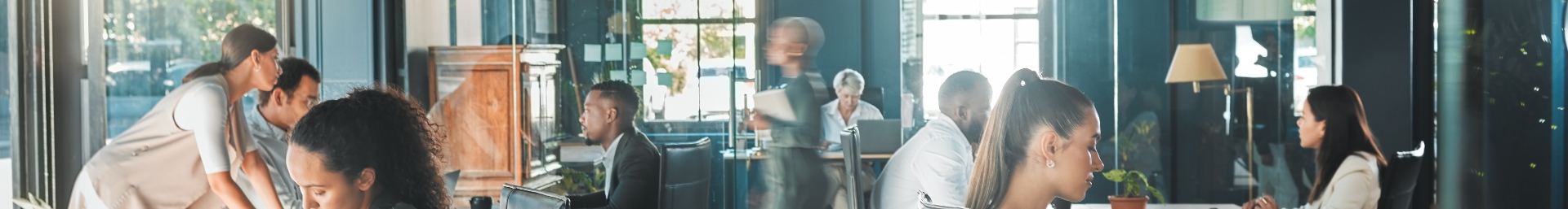 Various people busy working in an office