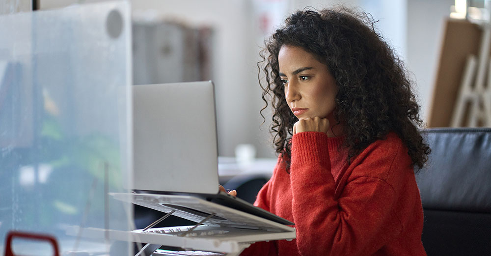 Female student focused while working on her laptop