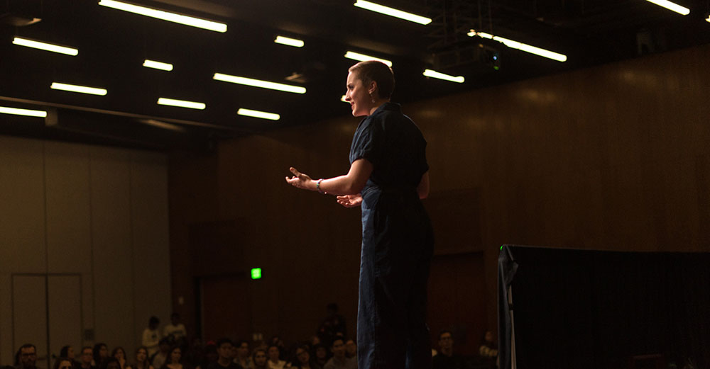 Person giving a speech to a crowd of people